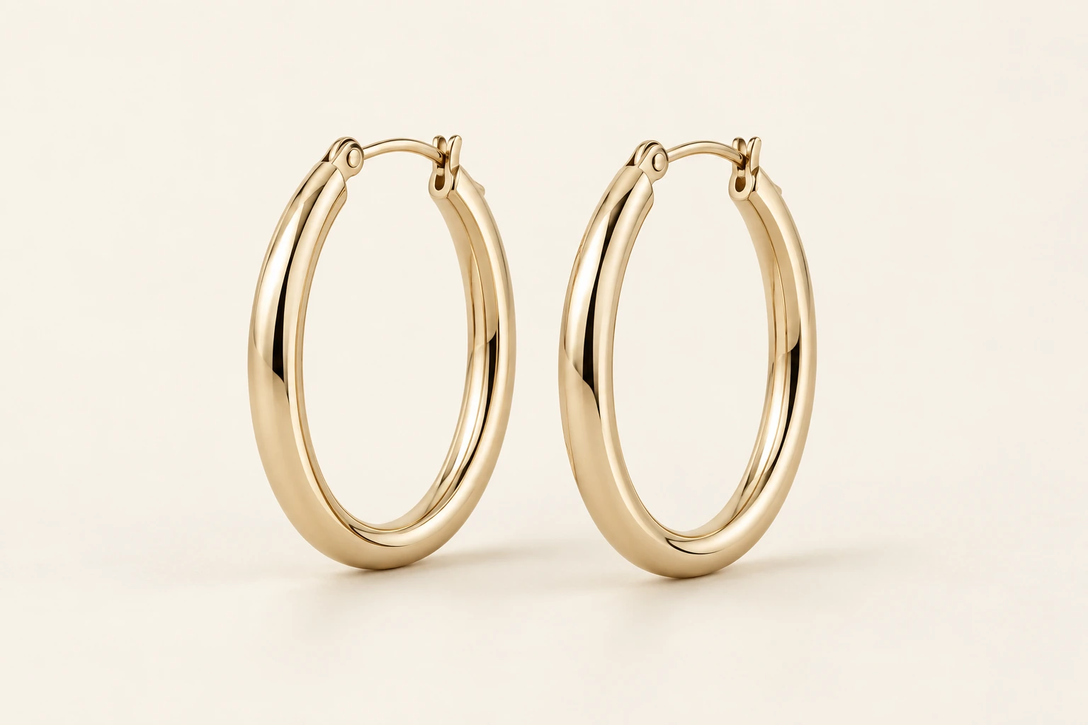 A pair of polished gold-tone oval hoop earrings