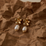 Gold Tone Flower and Pearl Look Drop Earrings — main view thumbnail